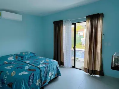 a blue bedroom with a bed and a sliding glass door at Casa Pacifico 46 Tamarindo in Santa Cruz