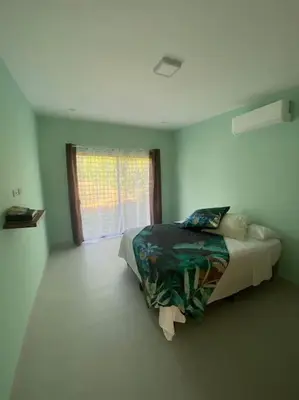 a bedroom with a bed in a room with a window at Casa Pacifico 46 Tamarindo in Santa Cruz