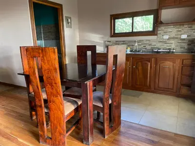 a kitchen with a wooden table and chairs at Hotel Almore in Monteverde Costa Rica