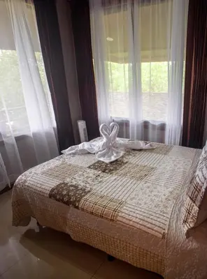 a bedroom with a bed in front of a window at Hotel Almore in Monteverde Costa Rica