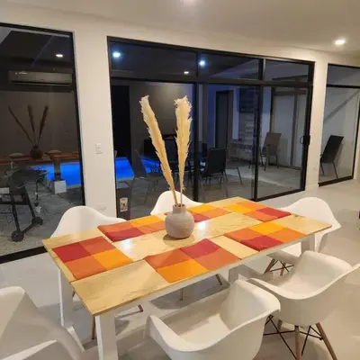 a dining room table with white chairs and a vase on it at Casa Bellota in Marbella