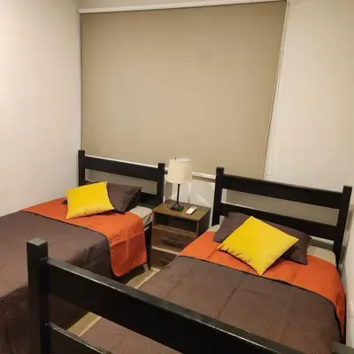a bedroom with two beds with yellow pillows at Casa Bellota in Marbella