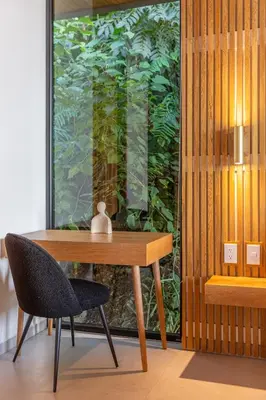 a wooden table and a chair in a room at Brand-new luxury Villa Element in Carmen