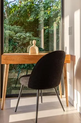 a wooden desk with a chair in front of a window at Brand-new luxury Villa Element in Carmen