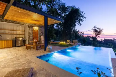 a swimming pool in the backyard of a house at Brand-new luxury Villa Element in Carmen