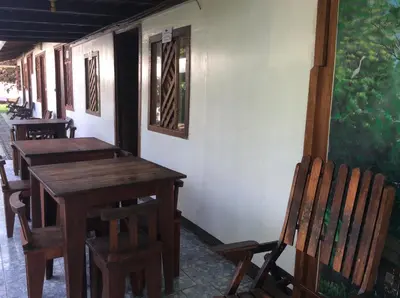 a wooden table and chairs sitting in a room at Cabinas Balcon del Mar Tortuguero in Tortuguero