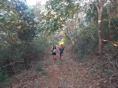 a man and woman walking down a dirt trail at Aura Bungalow in Tamarindo