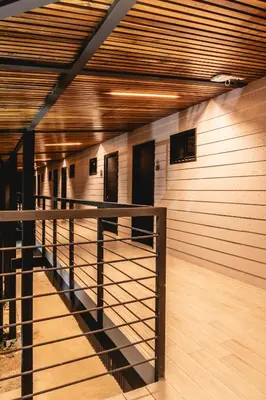a room with a staircase in a building with wooden walls at Club Marino Ballena in Uvita