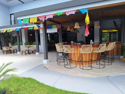 a bar with chairs and a table on a patio at Club Marino Ballena in Uvita