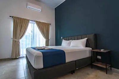 a bedroom with a large bed with a window at Club Marino Ballena in Uvita