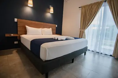 a bedroom with a large bed with a large window at Club Marino Ballena in Uvita