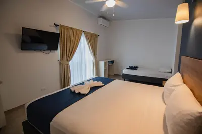 a bedroom with a bed with a towel on it at Club Marino Ballena in Uvita