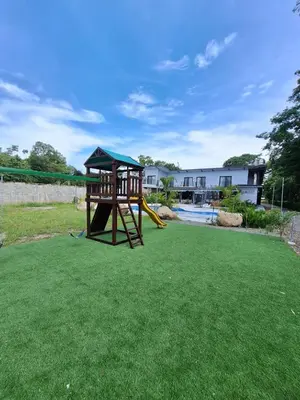 a playground with a slide in a yard at Club Marino Ballena in Uvita