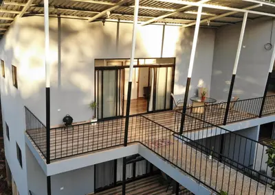a balcony of a house with a table on it at Hills House Pinilla Guanacaste in San José Pinilla
