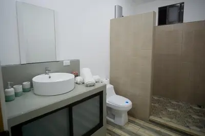 a bathroom with a sink and a toilet at Hills House Pinilla Guanacaste in San José Pinilla