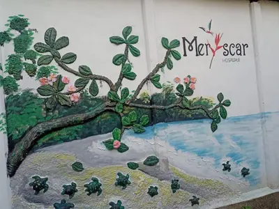 a painting of a tree on a wall at Hospedaje Meryscar in Tortuguero