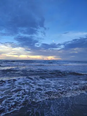 a view of the ocean from the beach at sunset at Hospedaje Meryscar in Tortuguero