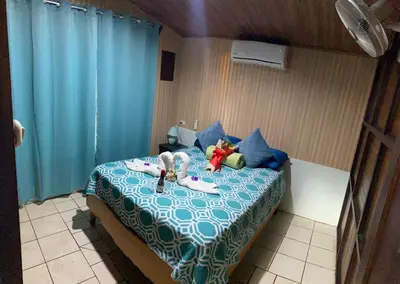a bedroom with a bed with stuffed animals on it at Cabaña que Tuanis in Fortuna