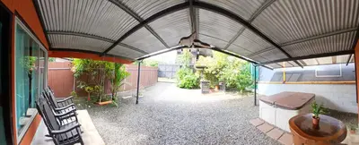 a covered patio with a toilet in a building at Cabaña que Tuanis in Fortuna