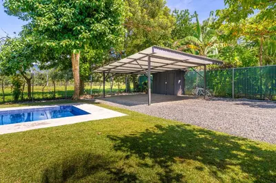 a pavilion with a swimming pool in a yard at Luxury 2 bedroom, walking distance to beach in Uvita