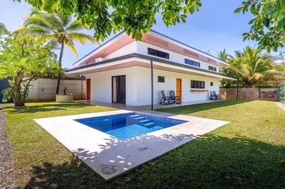 a house with a swimming pool in the yard at Luxury 2 bedroom, walking distance to beach in Uvita