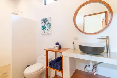 a bathroom with a sink and a mirror at Luxury 2 bedroom, walking distance to beach in Uvita