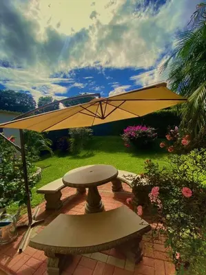 a yellow umbrella sitting on a brick patio at Peace Garden Apartment in Monteverde Costa Rica