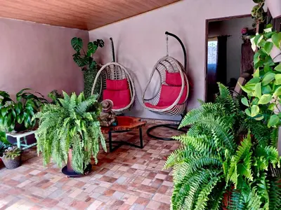 a room with two hanging baskets and plants at Peace Garden Apartment in Monteverde Costa Rica