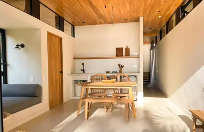 a dining room with a wooden table and chairs at Purapura Santa Teresa in Santa Teresa Beach