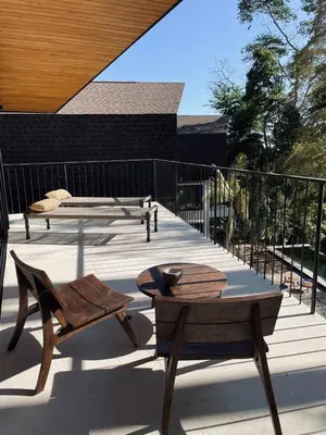 a wooden deck with a table and a bench at Purapura Santa Teresa in Santa Teresa Beach