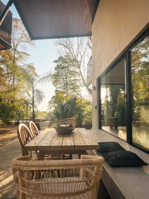 a wooden table and chairs on a patio at Purapura Santa Teresa in Santa Teresa Beach
