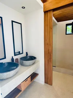 two sinks sitting on a counter in a bathroom at Purapura Santa Teresa in Santa Teresa Beach