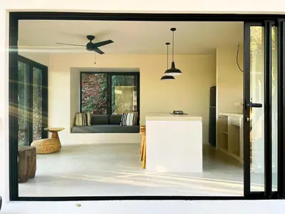 a kitchen and living room with a ceiling fan at Purapura Santa Teresa in Santa Teresa Beach