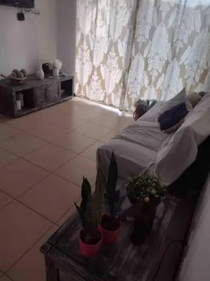 a bedroom with a bed with potted plants on a table at Casa de playa, Bejuco Costa Rica in Bejuco