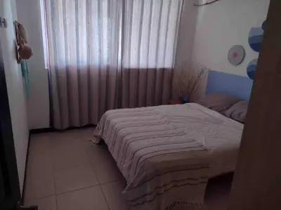 a bedroom with a bed and a window with curtains at Casa de playa, Bejuco Costa Rica in Bejuco