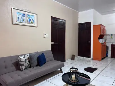 a living room with a couch and a table at Casa Tatich AC near Guanacaste Airport in Liberia