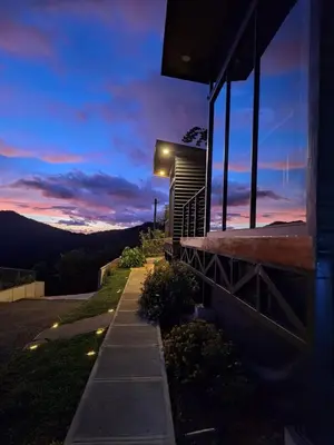 a house with lights on the side of it at dusk at Mon Bellis in El Copey