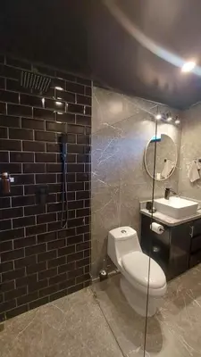 a bathroom with a white toilet and a sink at Mon Bellis in El Copey