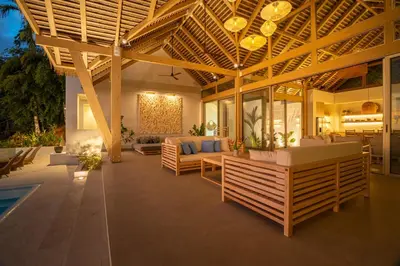 an outdoor living room with a large wooden roof at Casa Frenchie - by Pura Villas in Dominicalito