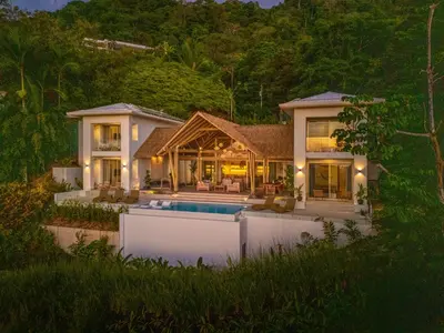 a house with a swimming pool in front of it at Casa Frenchie - by Pura Villas in Dominicalito