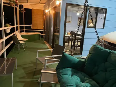 a living room with a green couch and chairs at Cabaña mirador Jacuzzi in Robles