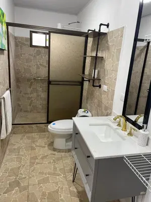 a bathroom with a toilet and a sink and a shower at Cabaña mirador Jacuzzi in Robles