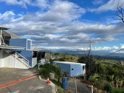 a blue and white house with a view at Cabaña mirador Jacuzzi in Robles