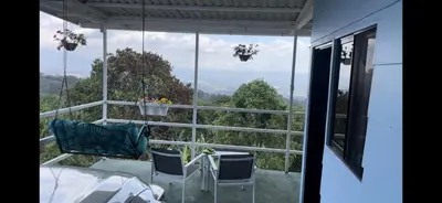 a view of a balcony with a table and chairs at Cabaña mirador Jacuzzi in Robles
