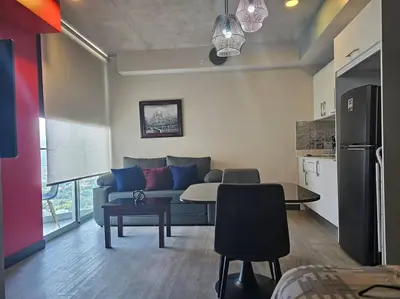 a living room with a couch and a table at Secrt 3014 in San José