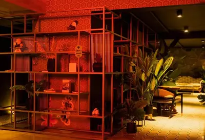 a red book shelf with a potted plant in a room at Secrt 3014 in San José