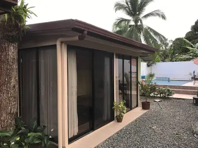 a screened in porch of a house at Casa del Árbol in Quepos