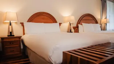 a hotel room with two beds and two lamps at Fondavela Hotel in Monteverde Costa Rica