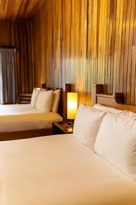 a hotel room with two beds and a lamp at Fondavela Hotel in Monteverde Costa Rica