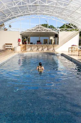 a person in the water in a swimming pool at Fondavela Hotel in Monteverde Costa Rica
